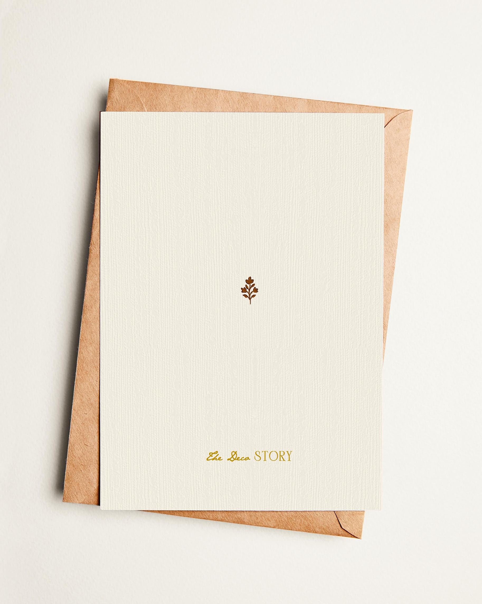 Card with a brown envelope on a light beige background
