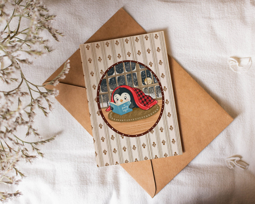 Card with a penguin design on a brown envelope with decorative elements.