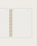 Notebook page with gold spiral binding on a white background