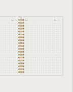 Notebook page with gold spiral binding on a white background