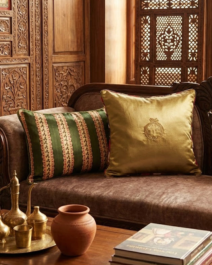 Decorative living room with a brown sofa, patterned pillows, and a wooden wall.