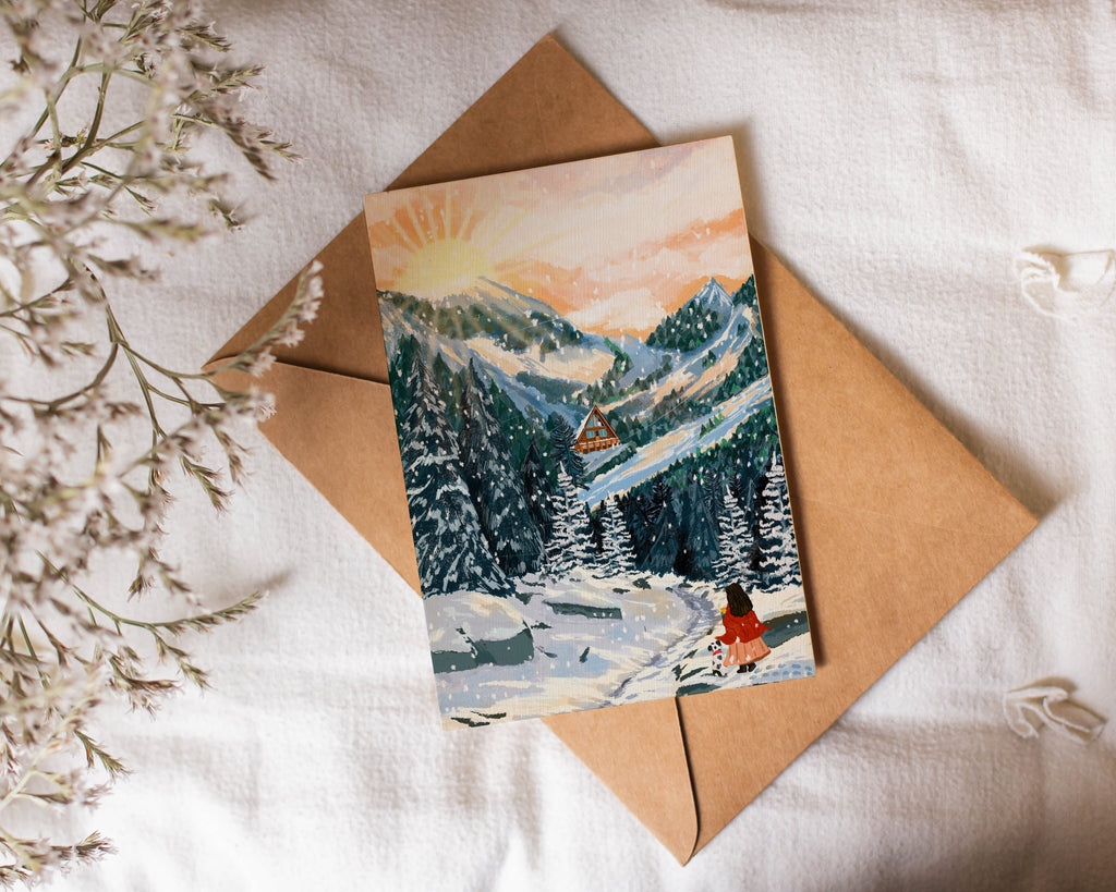 Girl with a cute dog in a winter landscape card with envelope on a textured surface 