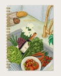 Notebook cover with illustration of a kitchen counter with vegetables, flowers, and a bottle of wine.