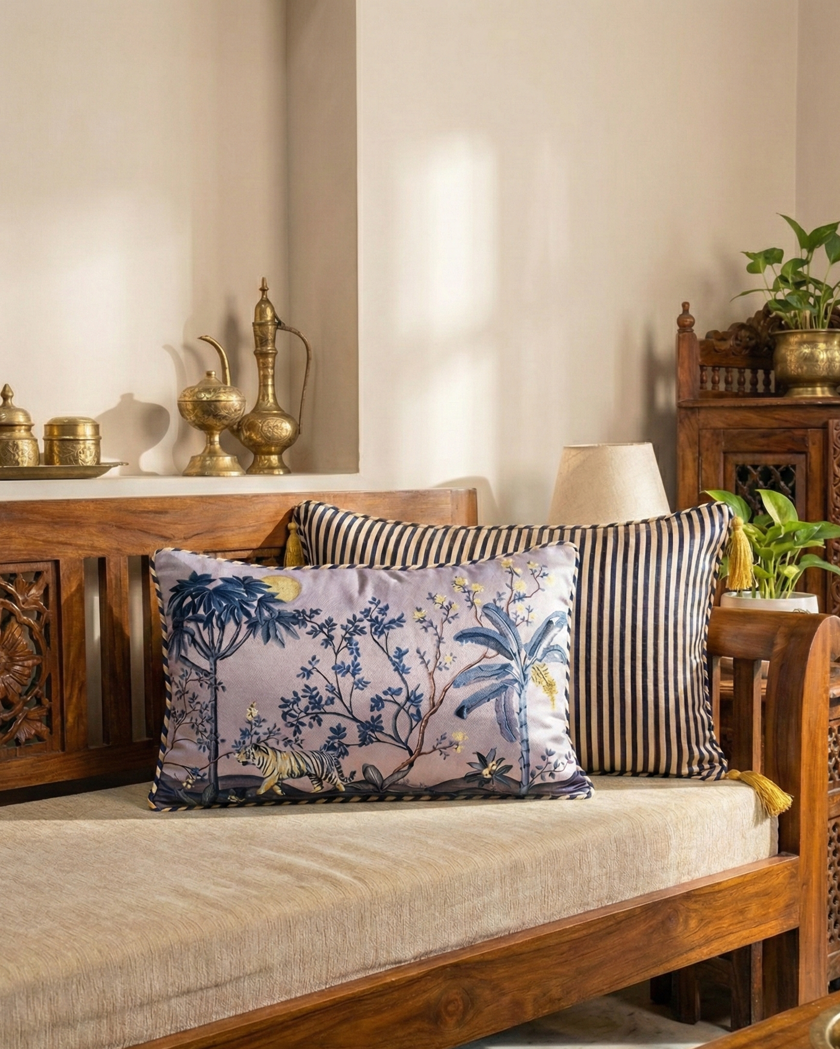 Decorative pillows on a wooden sofa with a traditional setting
