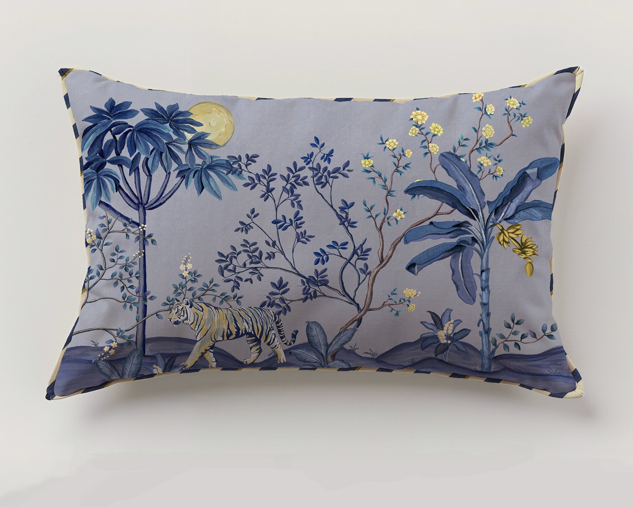 Decorative pillow with a nature-themed design featuring trees, flowers, and a tiger on a light blue washed background.