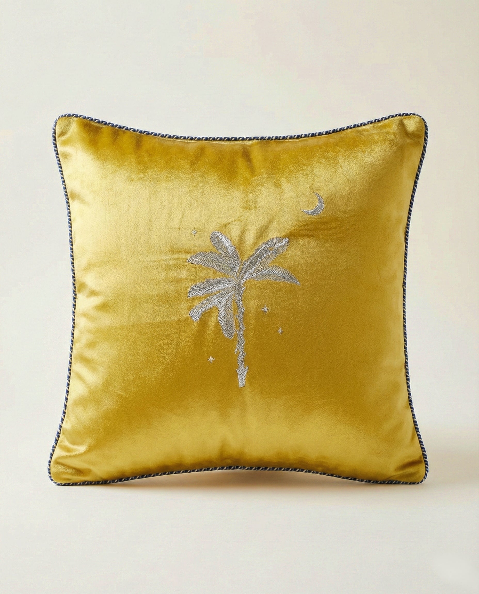 Gold Mashru cushion cover with palm tree design on a beige background