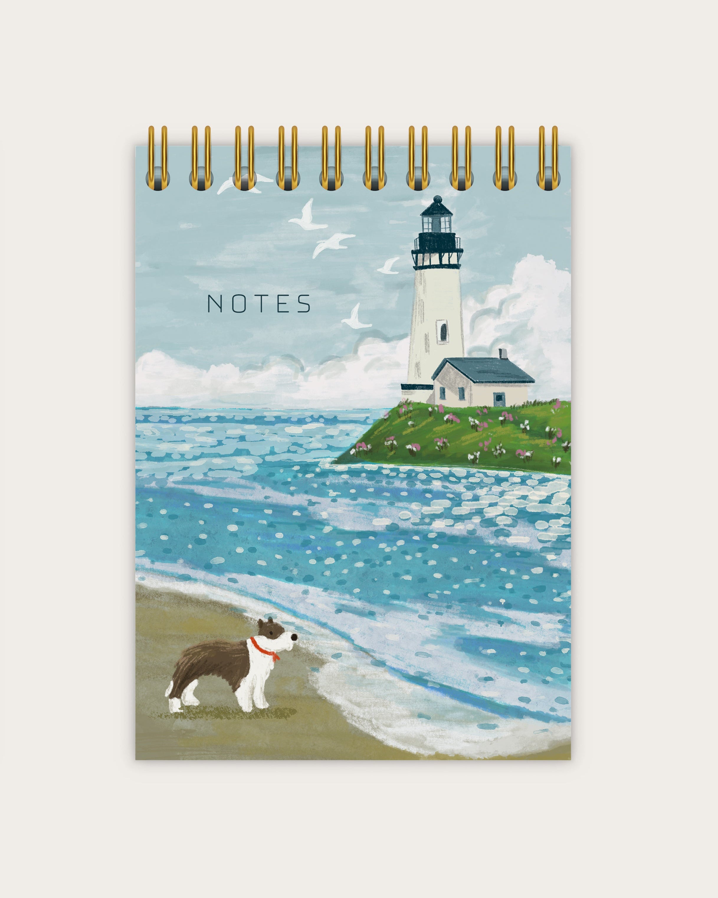 Notebook with a lighthouse and dog illustration on the cover