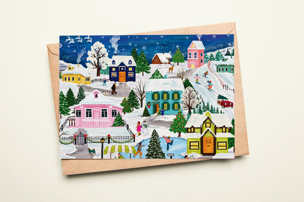 Christmas card with a winter village scene on a white background