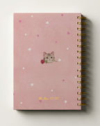 Pink journal with cat illustration and heart patterns on a white background