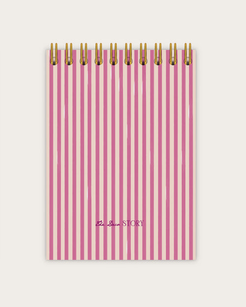 Pink striped notebook with gold wire binding on a white background