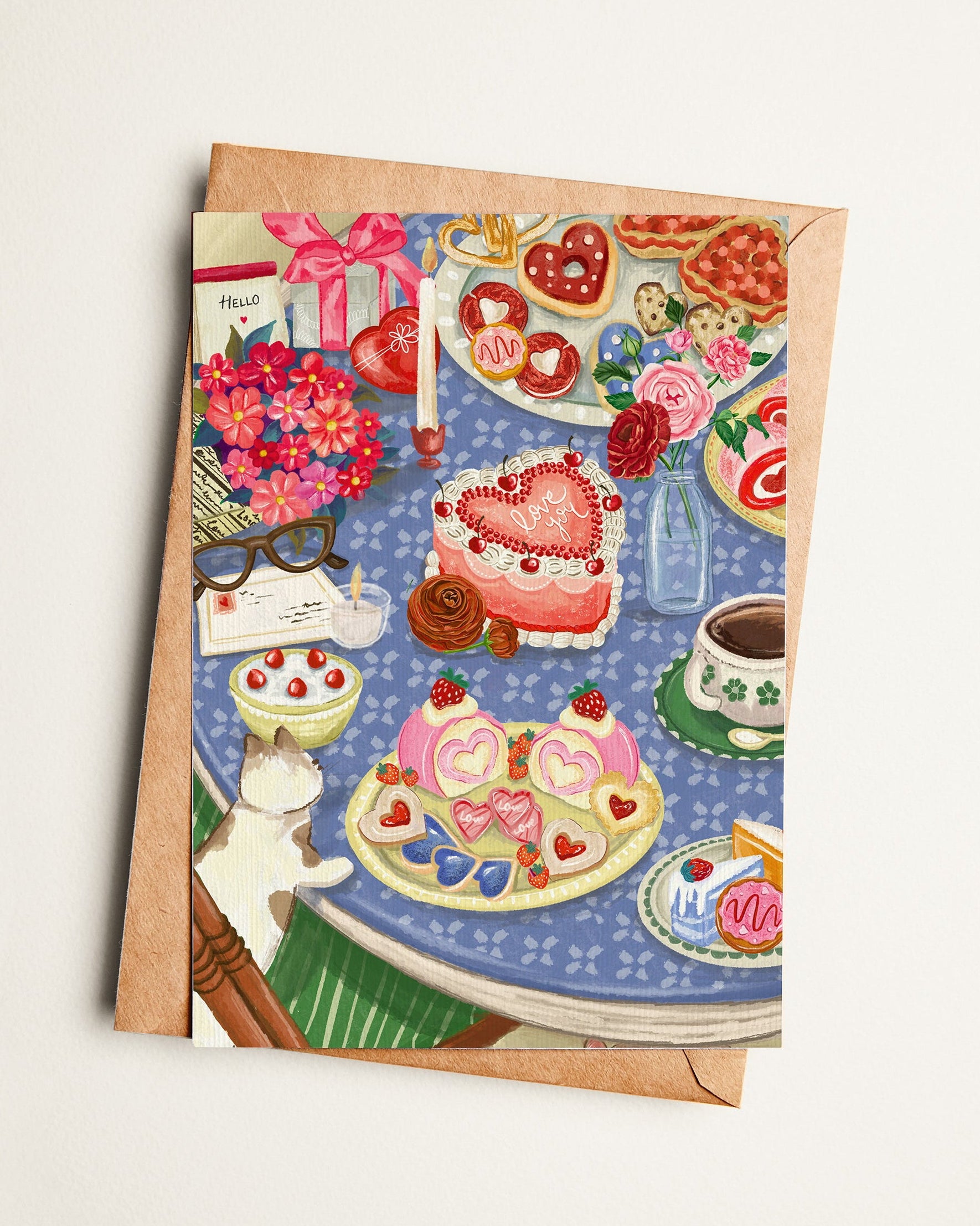 Greeting card with a colorful illustration of a cat, cake, and various items on a table.