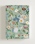 A5-sized journal with a hard cover in mint green color featuring a floral design with birds, labeled 'JOURNAL' on the cover. Perfect for gifting.