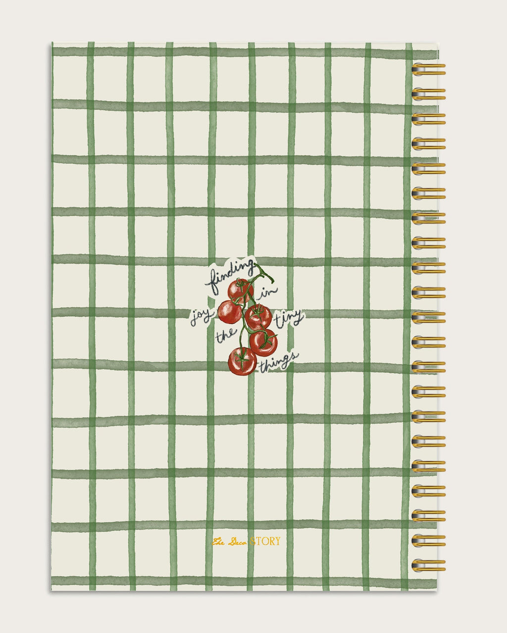 Notebook back with green grid pattern and cherry illustration on a off white background
