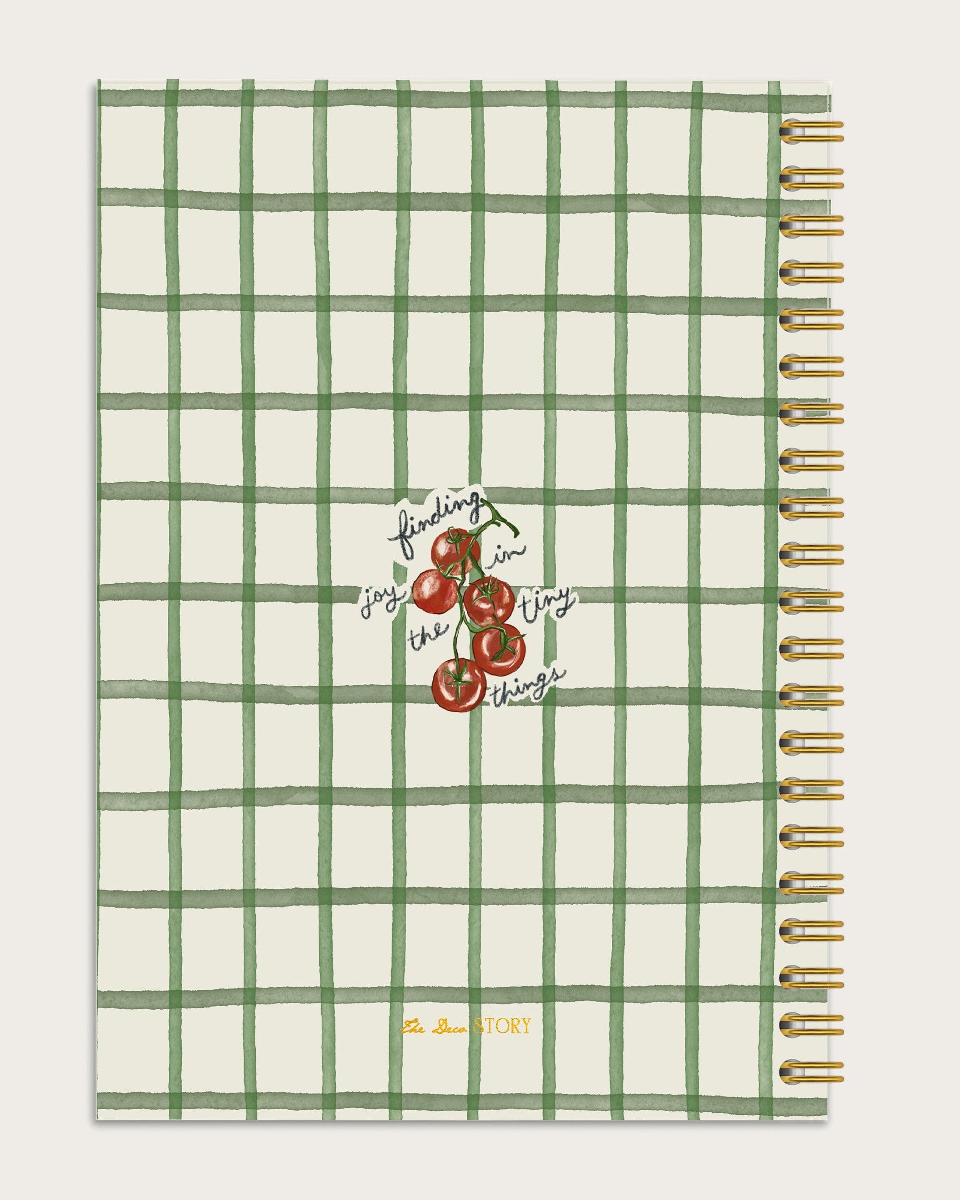 Notebook back with green grid pattern and cherry illustration on a off white background