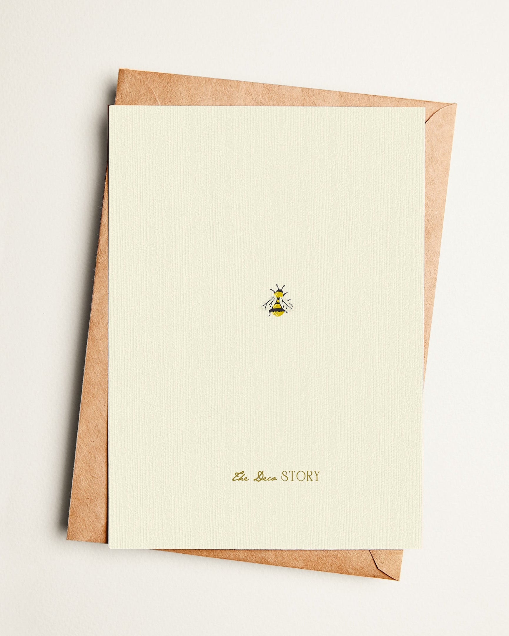Greeting card with brown envelope on a light beige background